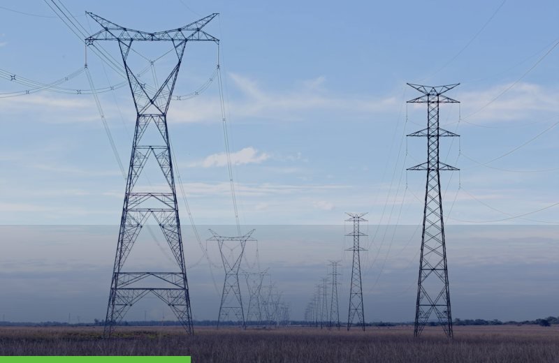 Electricity pylons across an open field